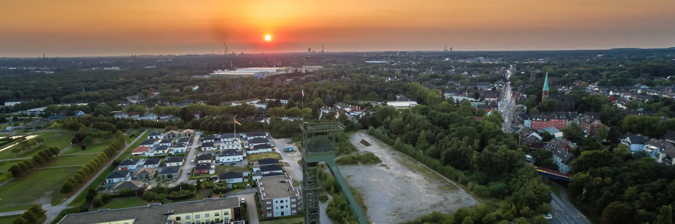 Bild der Zeche Osterfeld in Oberhausen im Hintergrund die untergehende Sonne, Teile von Oberhausen und von Duisburg